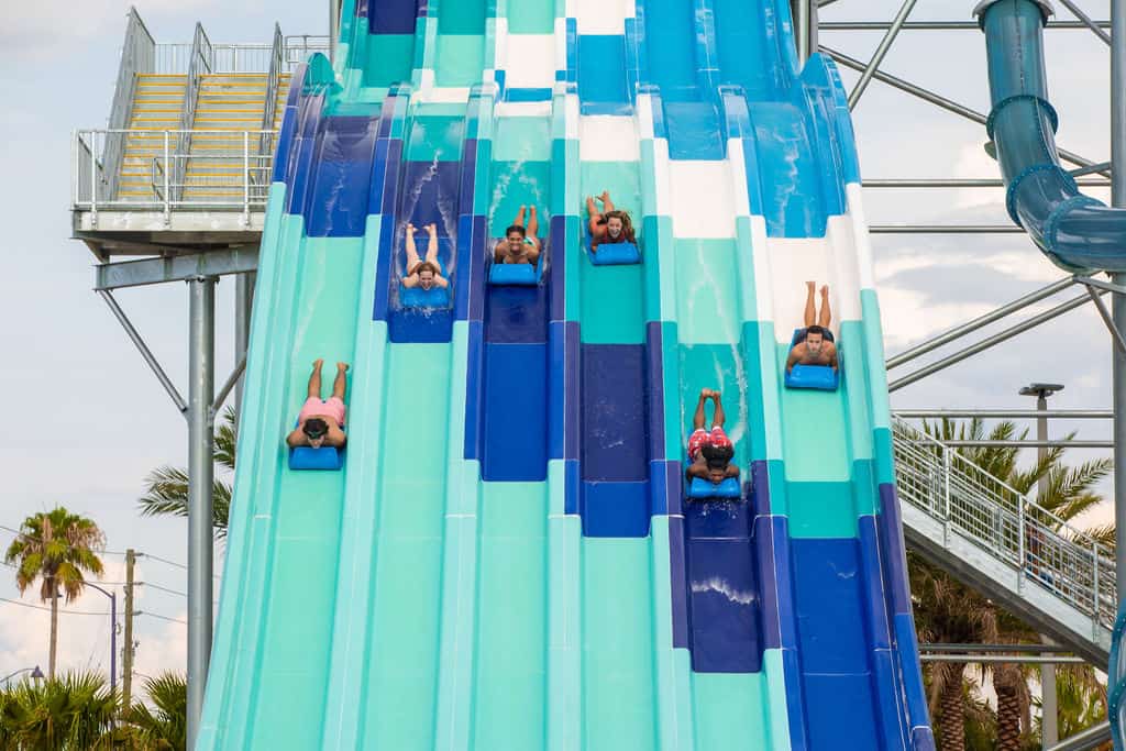 People racing on mats down the Reply Racers water slide at Island H2O Live Water Park.