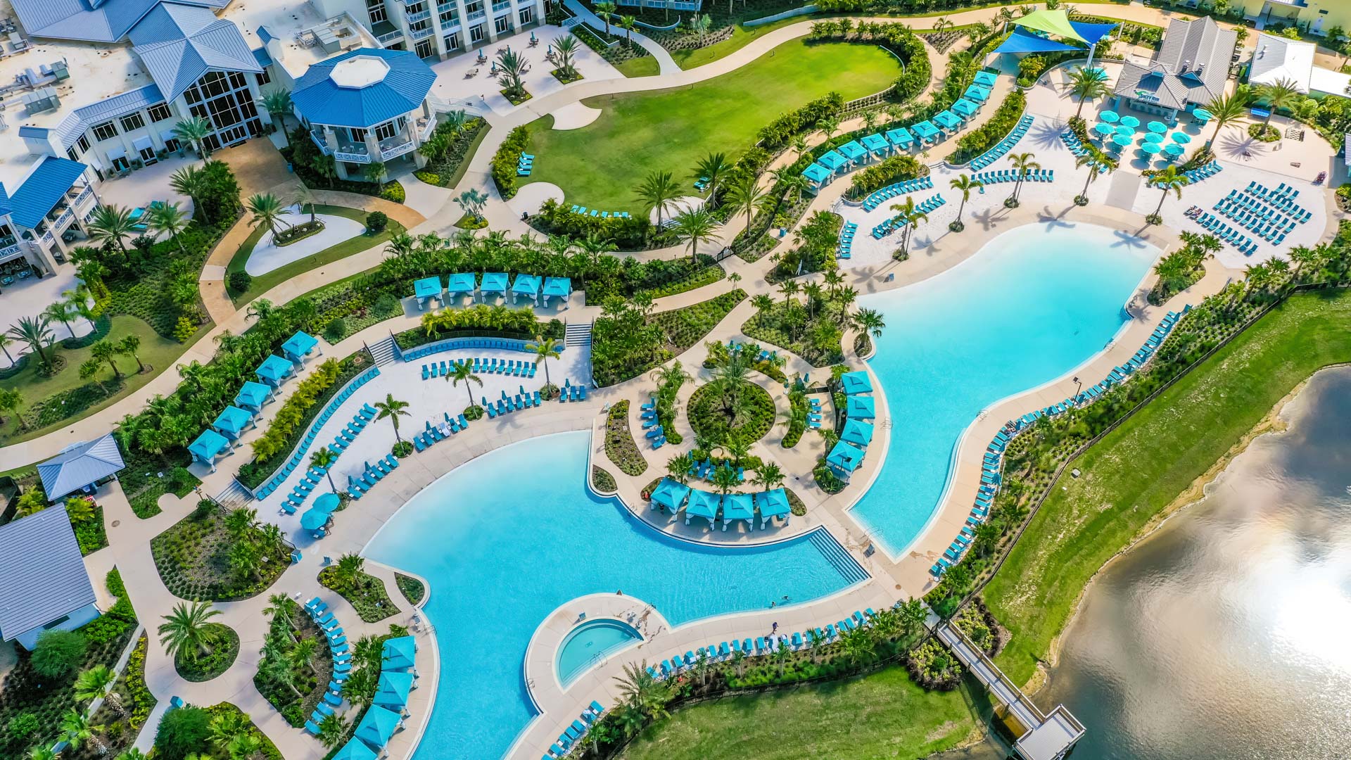 Aerial view of Margaritaville Resort Orlando and its Fins Up Beach Club and pools.