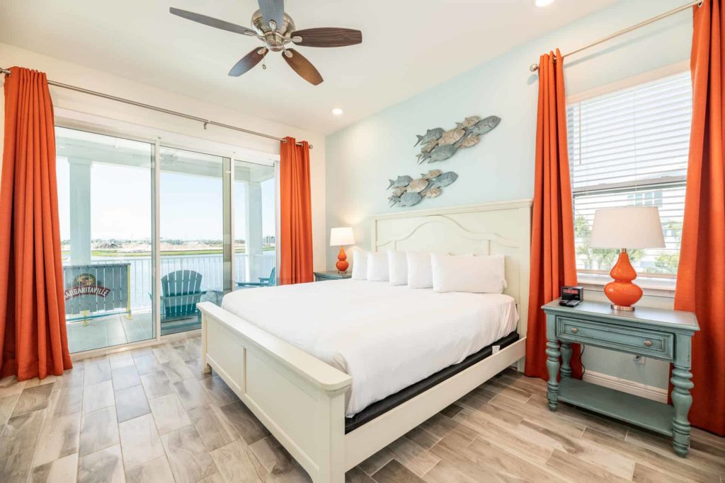 Large king suite bedroom with balcony access: 2 Bedroom Water’s Edge Cottage