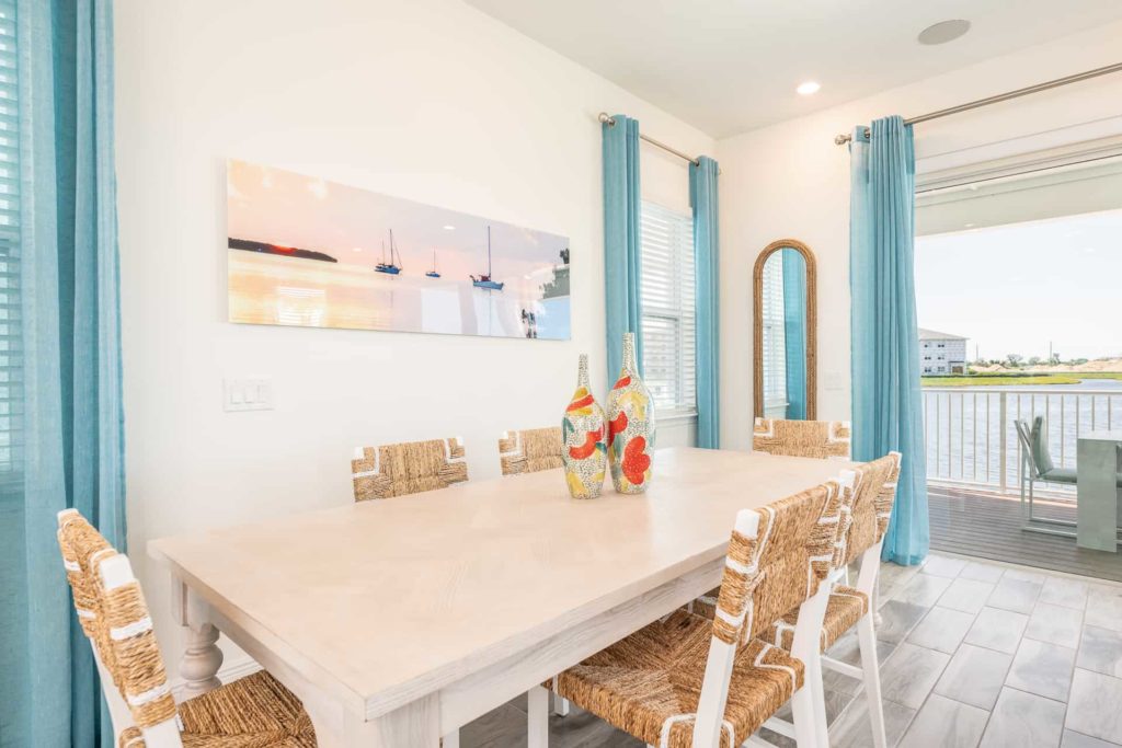 Dining room with outdoor balcony access: 2 Bedroom Water’s Edge Cottage