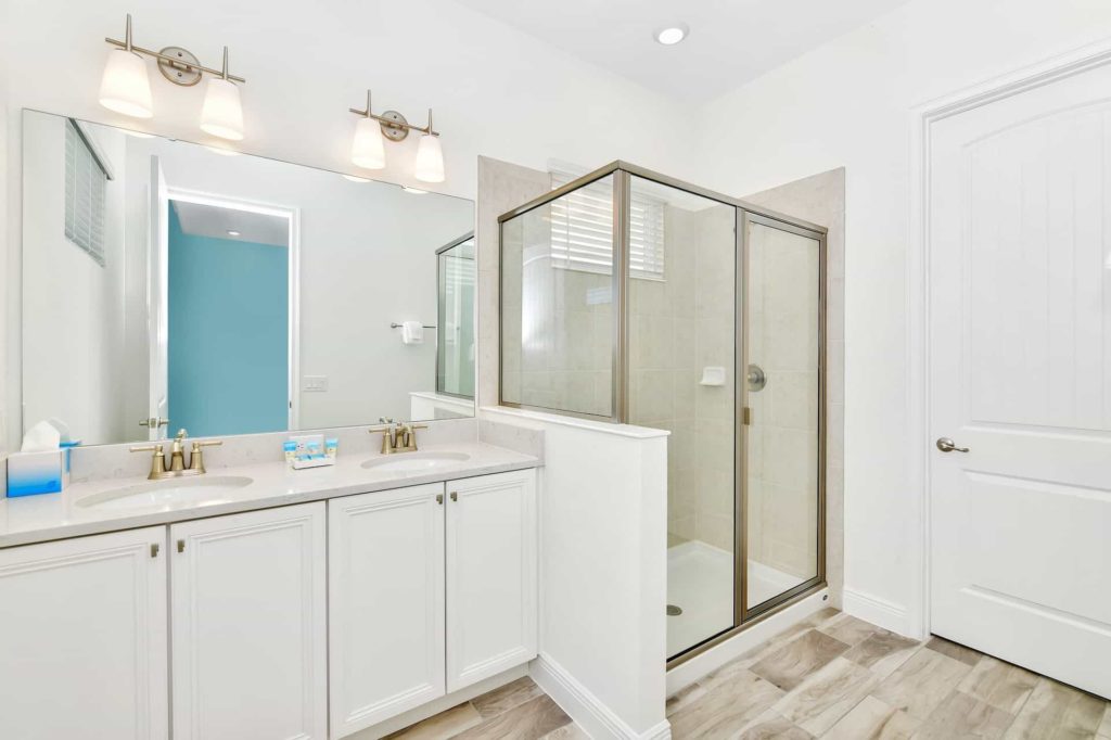 Master bathroom with walk-in shower and two sinks: 3 Bedroom Water’s Edge Cottage with Pool
