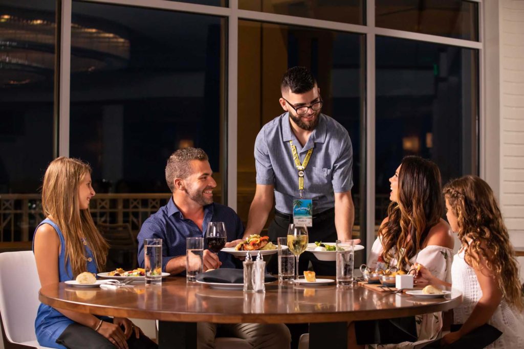 Euphoria server brings food to a family at Margaritaville Resort Orlando.