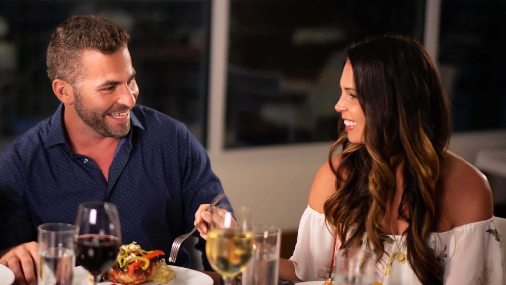 Couple enjoying a romantic meal at Euphoria Fish House at Margaritaville Resort Orlando