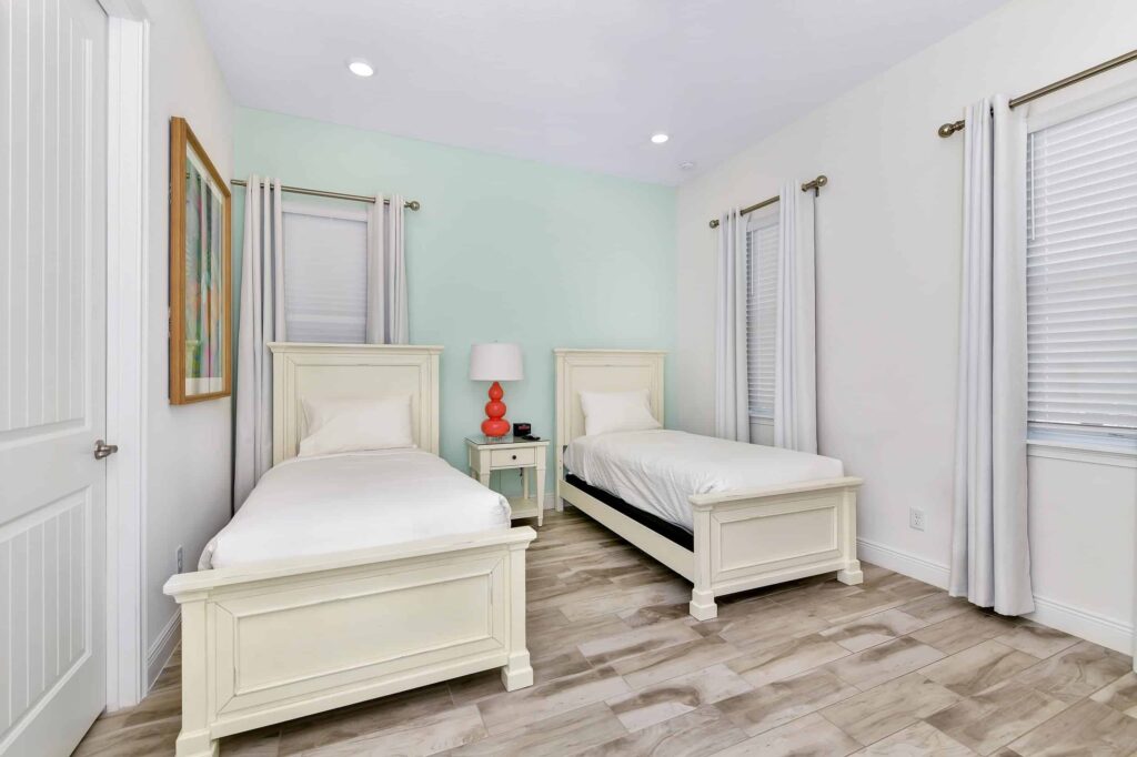 Bedroom 4 with twin single beds and single side table: 6 Bedroom Cottage