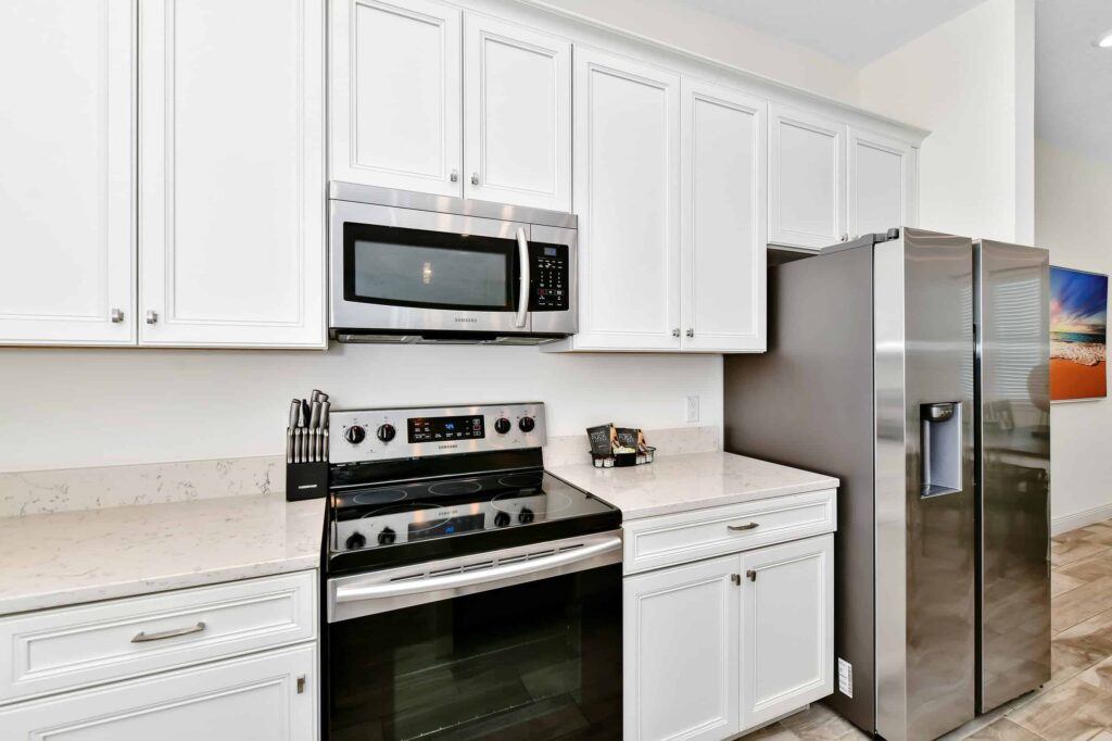 Oven range, microwave, and cabinets inside full kitchen: 6 Bedroom Cottage