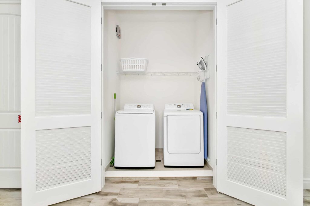 Laundry closet with washer, dryer, and ironing board: 6 Bedroom Cottage