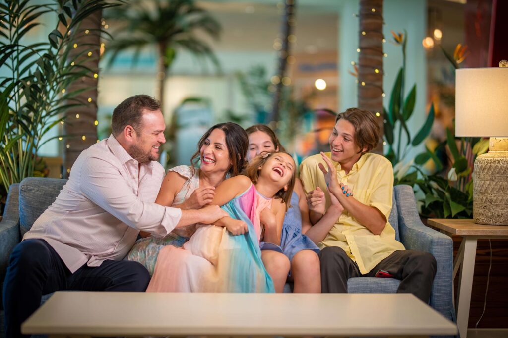 Family sitting in the lobby at Margaritaville Resort Orlando