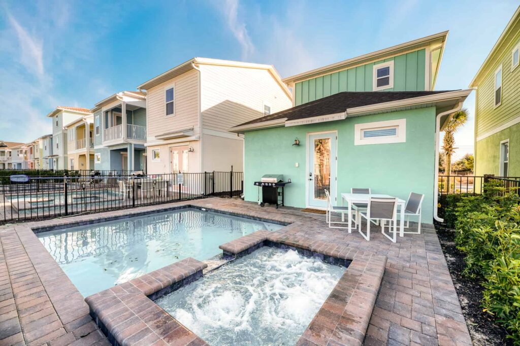 Private backyard highlighting hot tub and pool: 2 Bedroom Elite Cottage