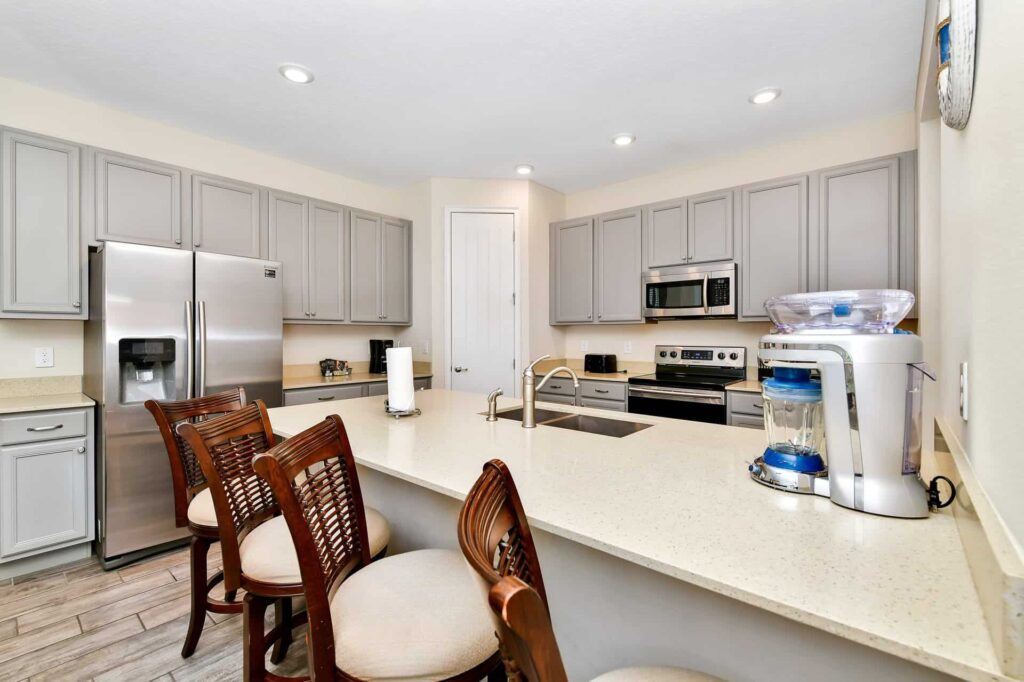 Fully equipped kitchen featuring large island with sink and Margaritaville Frozen Concoction Maker: 7 Bedroom Cottage