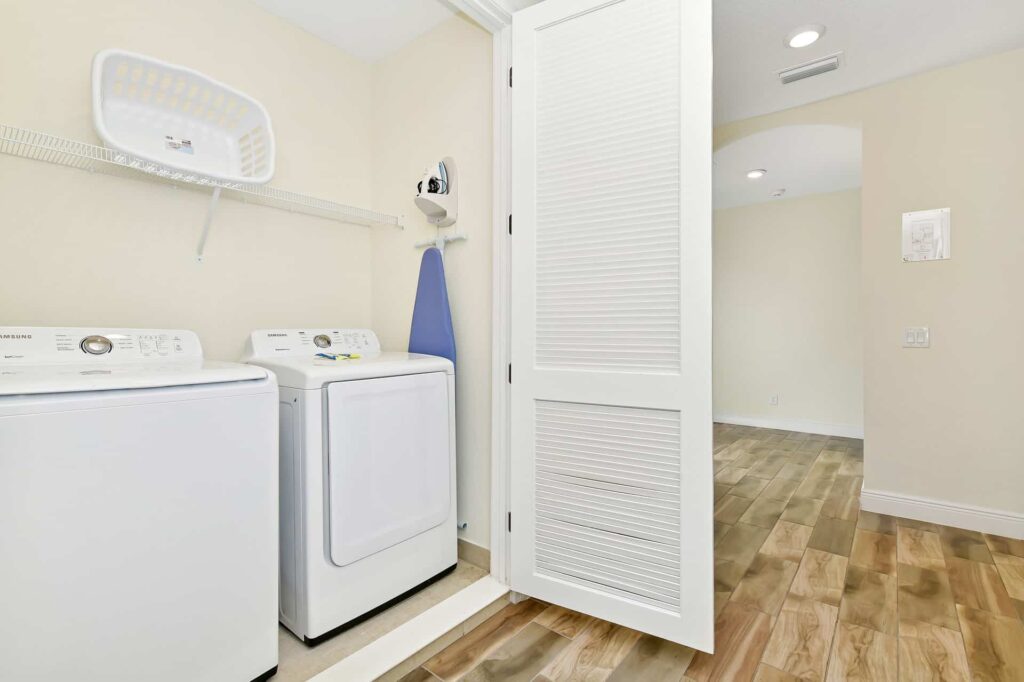 Laundry room with washer, dryer, and ironing board: 8 Bedroom Cottage