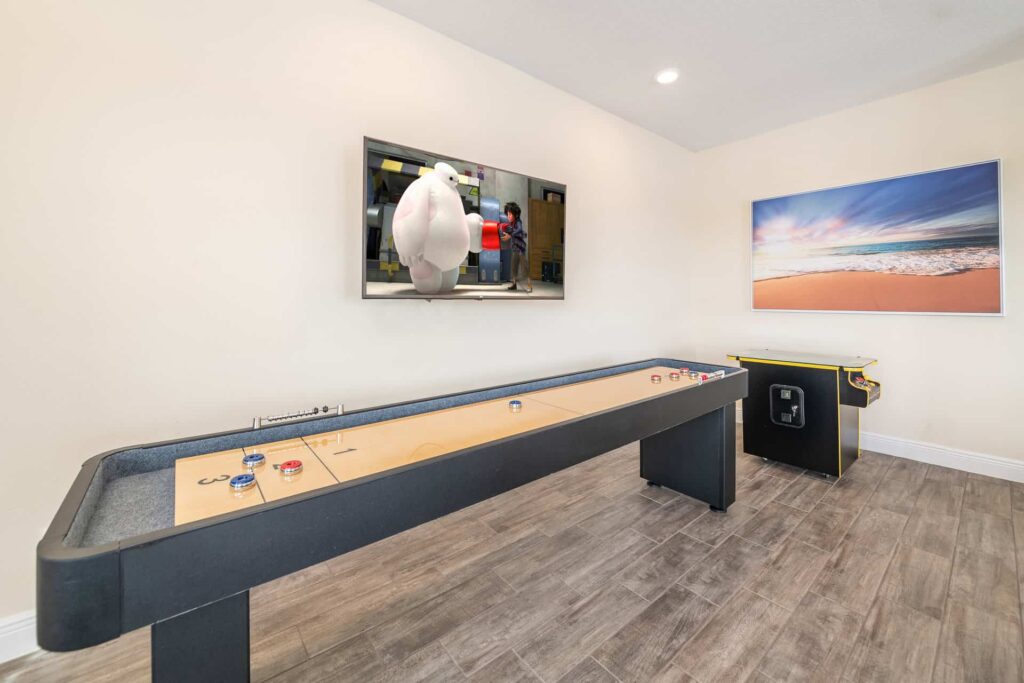 Shuffleboard, wall-mounted TV, and cocktail arcade cabinet: 8 Bedroom Elite Cottage (Gaming tables may not be available in every cottage)