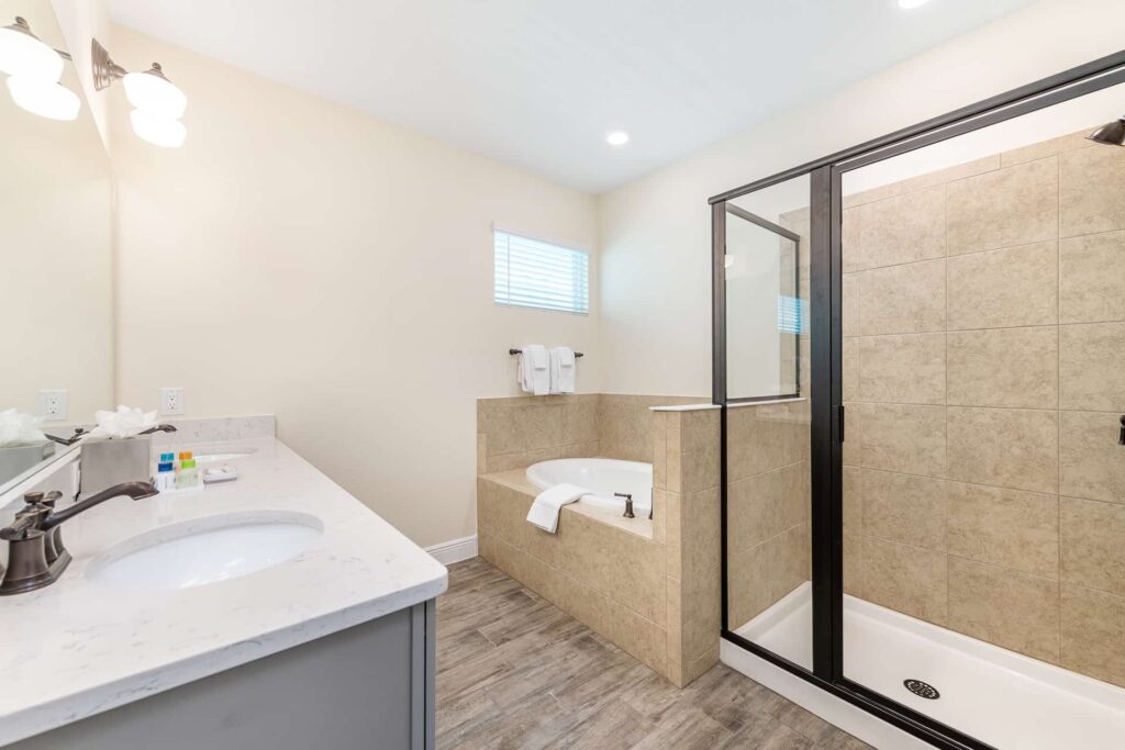 Bathroom 5 with double sinks, walk-in shower, and separate bathtub: 8 Bedroom Premium Cottage