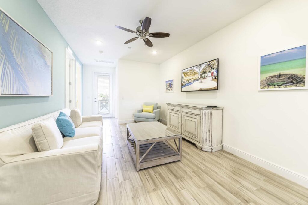 Upper-level loft with sofa, coffee table, and wall-mounted TV: 8 Bedroom Superior Cottage
