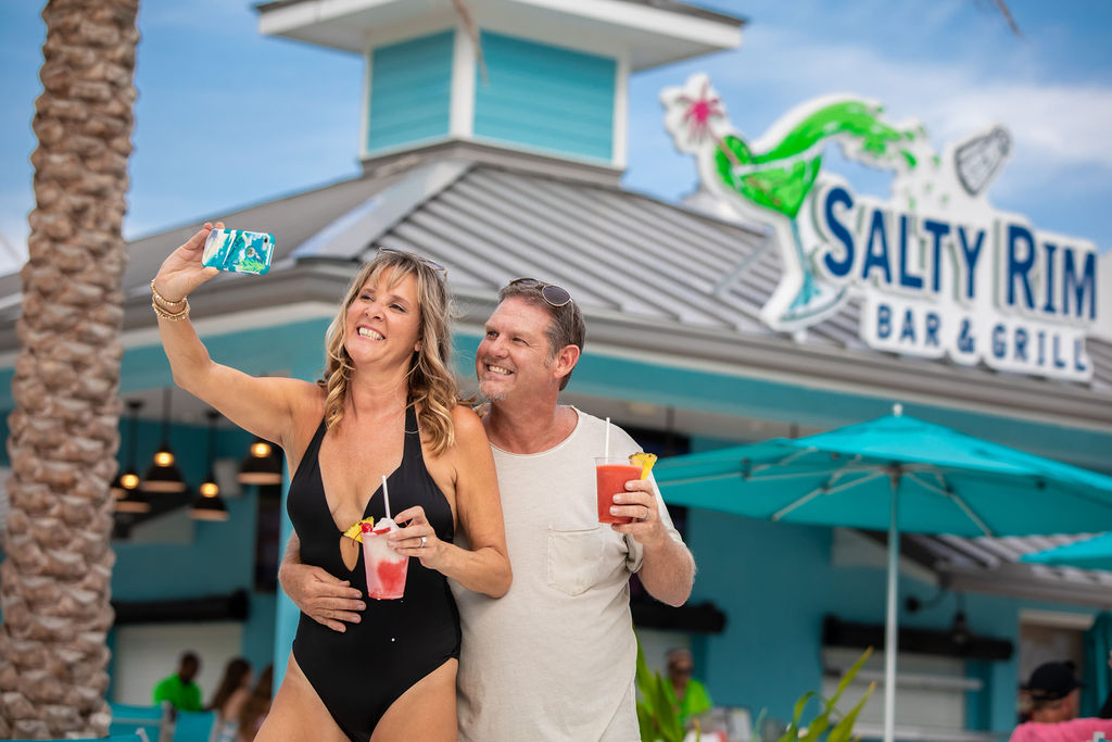 Couple posing for a selfie photo with drinks at Salty Rim Bar and Grill