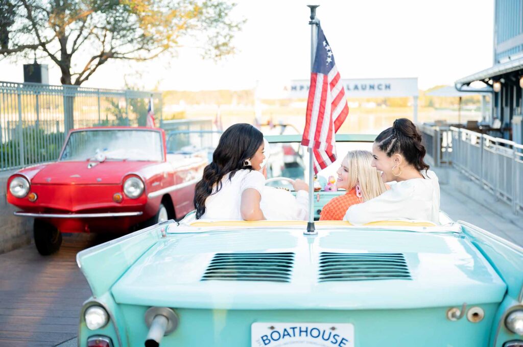 Group of friends riding in an amphicar at Disney Springs