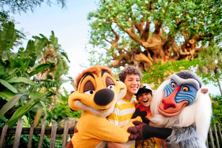 Brothers taking a photo with Timone and Rafiki from the Lion King movie at Disney's Animal Kingdom