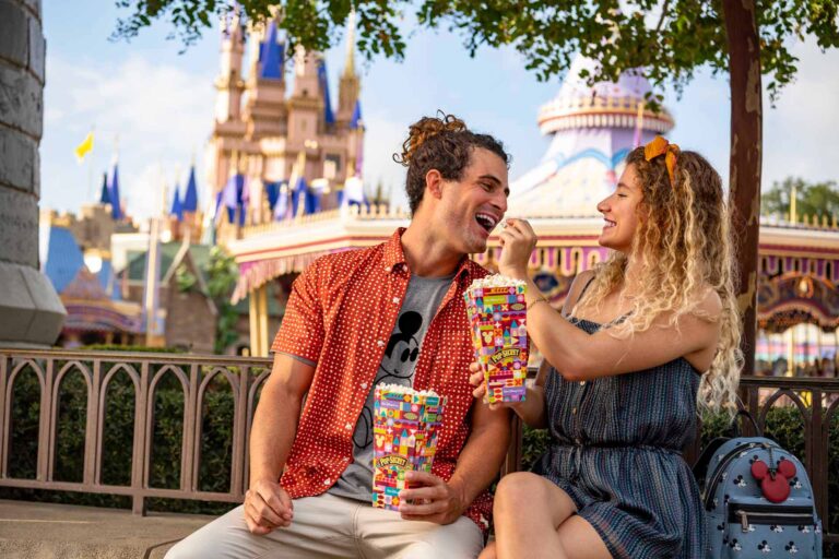 Couple sharing popcorn at the Magic Kingdom