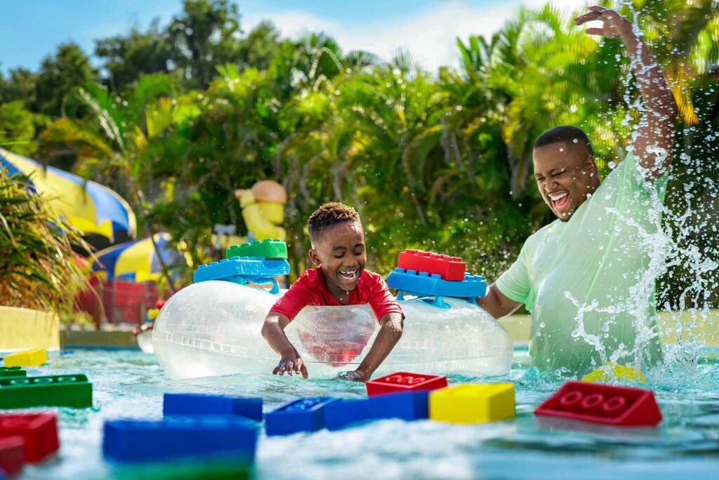 Vater und Sohn spielen mit Legosteinen im Pool des LEGOLAND Water Park