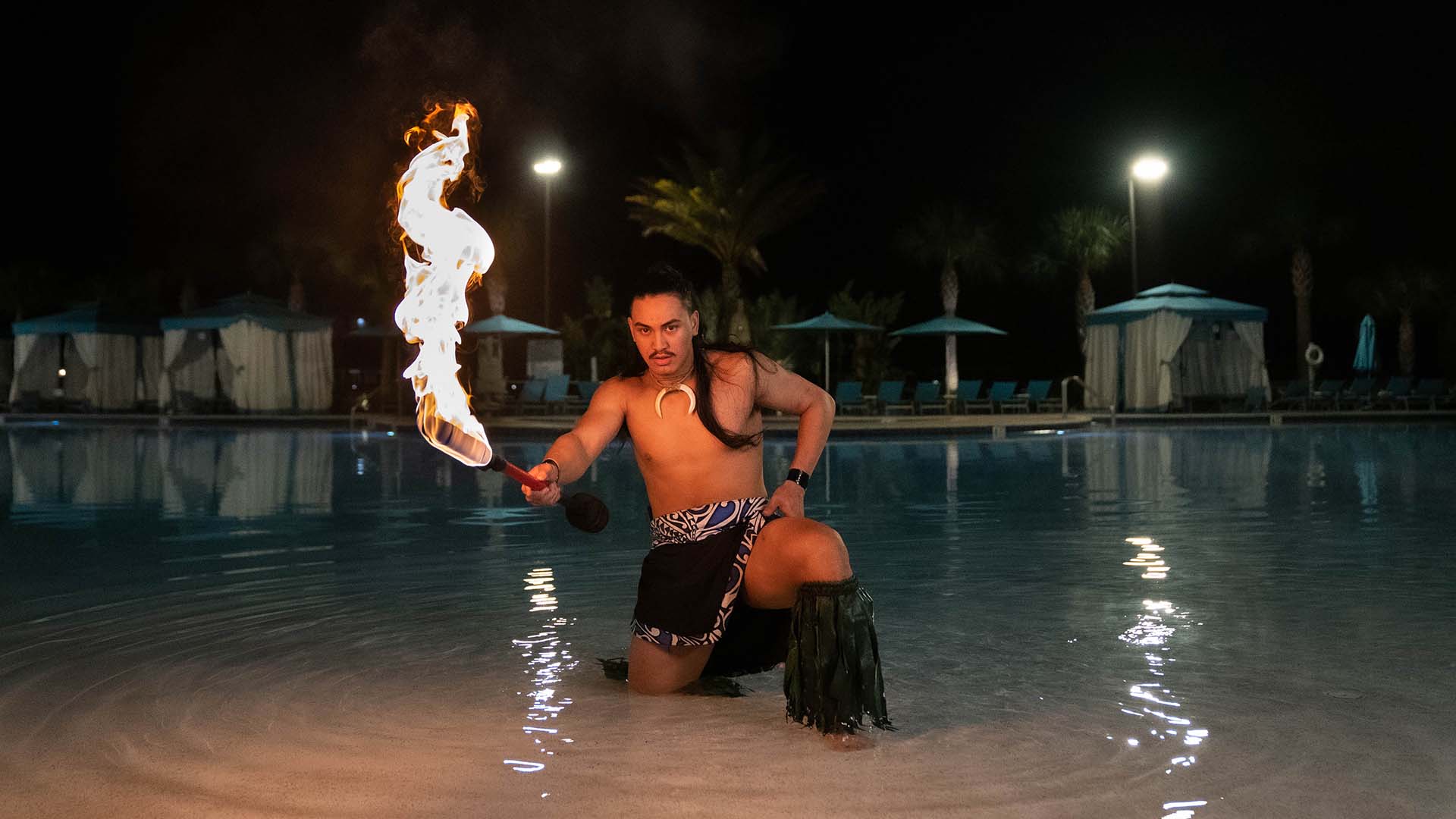 Fire dancer performing at Margaritaville Resort Orlando’s Fins Up Beach Club