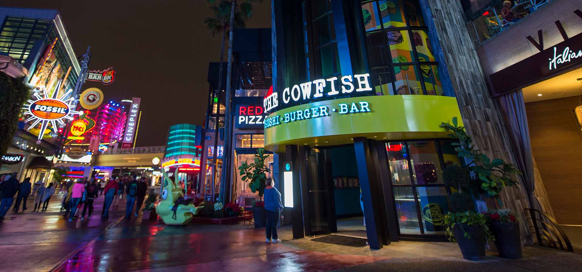 Person looking at the exterior menu of the Cowfish Sushi Burger Bar at Universal CityWalk