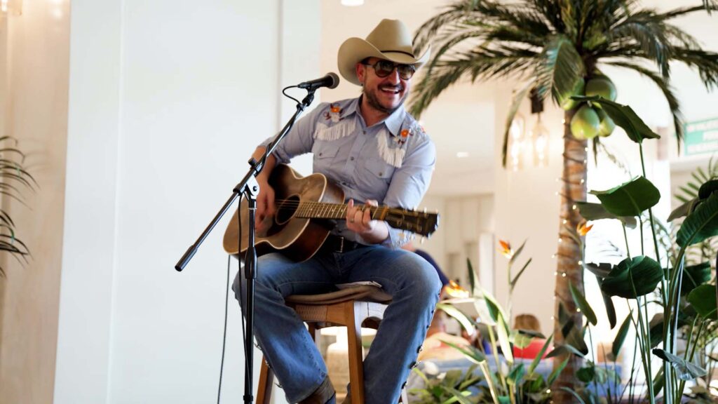 Jason Link playing guitar in the Margaritaville Resort Orlando lobby