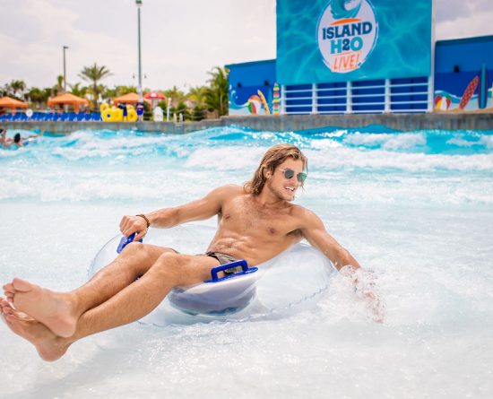 Man floating on a tube in the Live Lagoon wave pool at Island H2O Live Water Park.