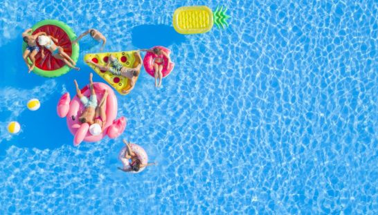 long-stay Family floating in colorful pool floats.