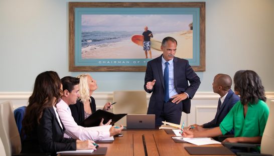 Group of co-workers hold a corporate meeting in one of Margaritaville Resort Orlando’s meeting suites.