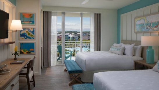 stay-again Furnished hotel room at Margaritaville Resort Orlando with balcony view of the Fins Up Pool.