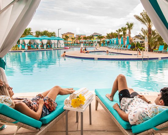 story-3-oasis Couple relaxing in a poolside cabana at Margaritaville Resort Orlando.